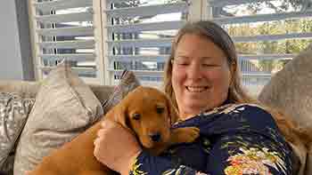 Ilmarie cuddling a puppy